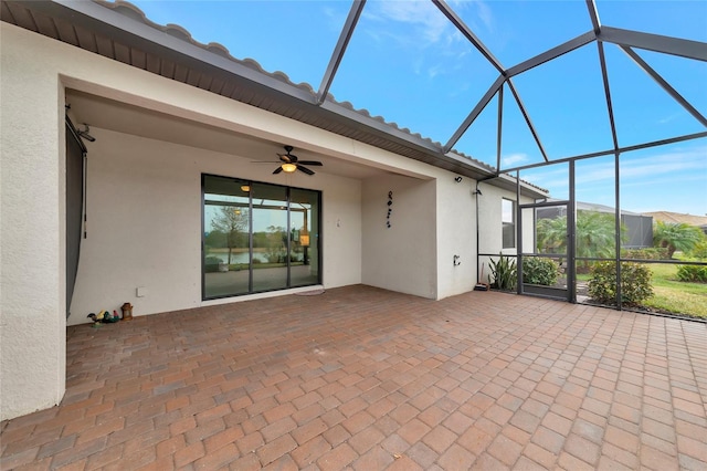 unfurnished sunroom featuring ceiling fan