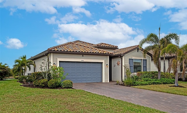 mediterranean / spanish house featuring a front yard and a garage