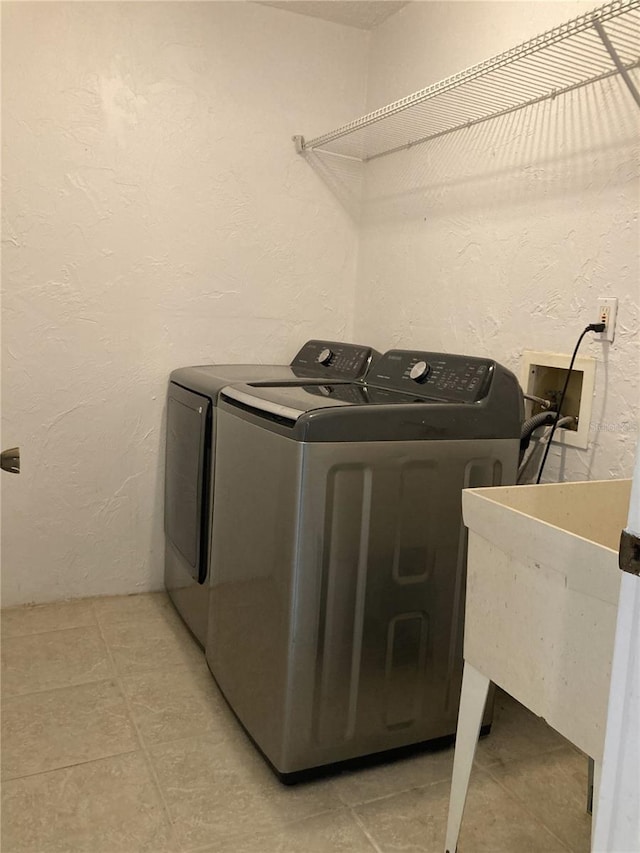 clothes washing area featuring washer and dryer and sink