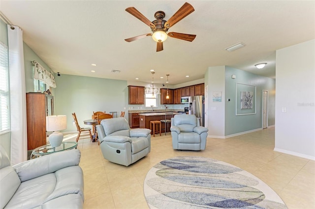 living room featuring ceiling fan and sink