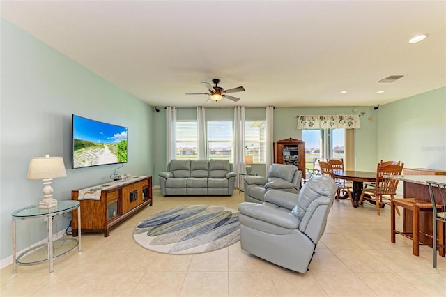 tiled living room featuring ceiling fan