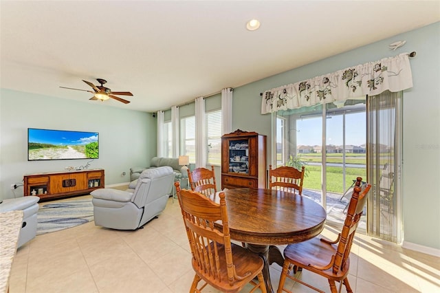 tiled dining area with ceiling fan