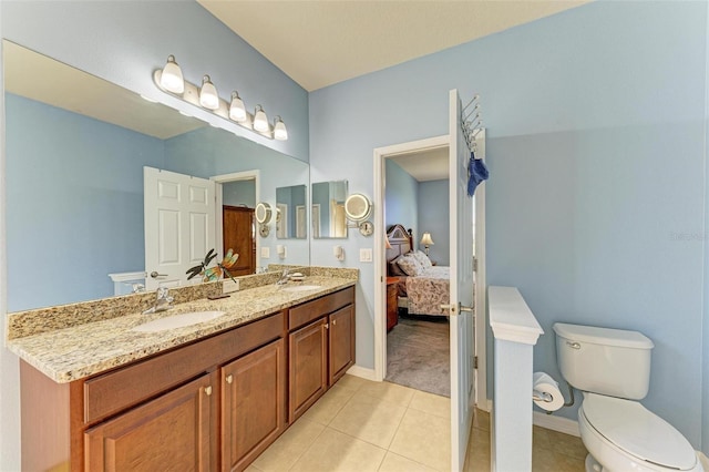 bathroom featuring tile patterned flooring, vanity, and toilet