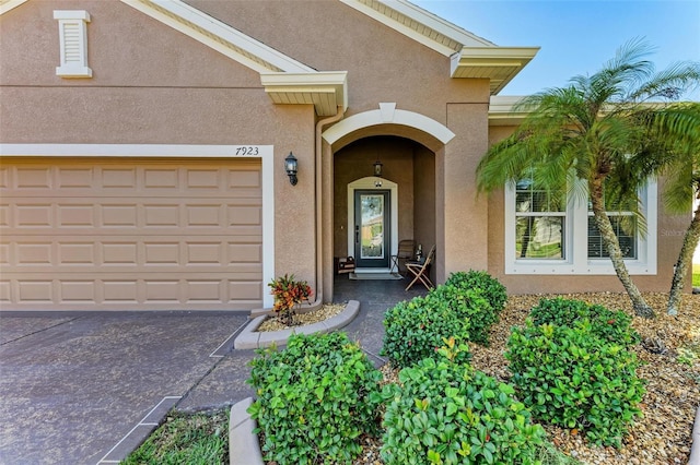 view of exterior entry with a garage