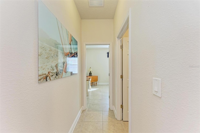 hallway featuring light tile patterned floors