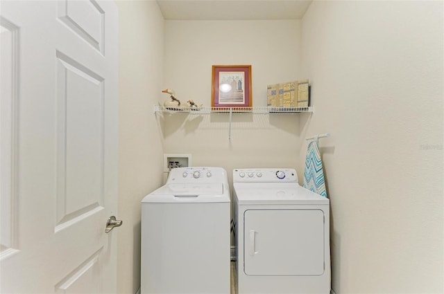 laundry area with washing machine and clothes dryer