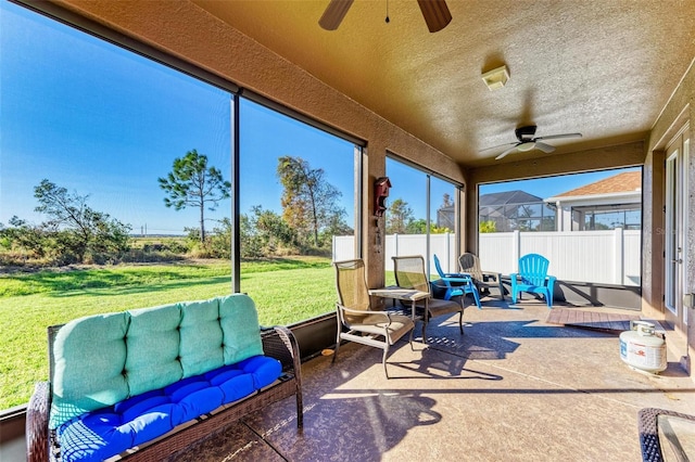 sunroom with plenty of natural light and ceiling fan