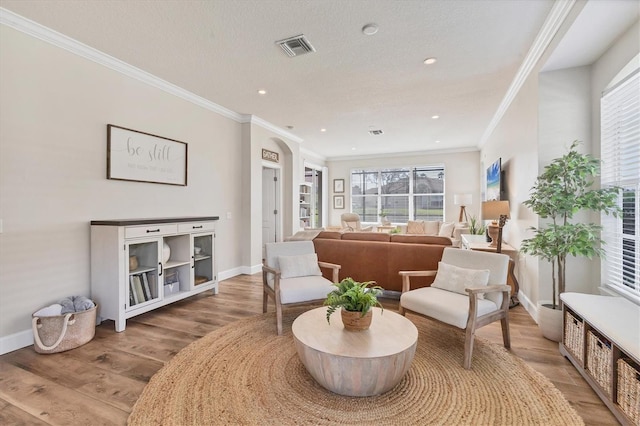 sitting room featuring light hardwood / wood-style flooring and crown molding