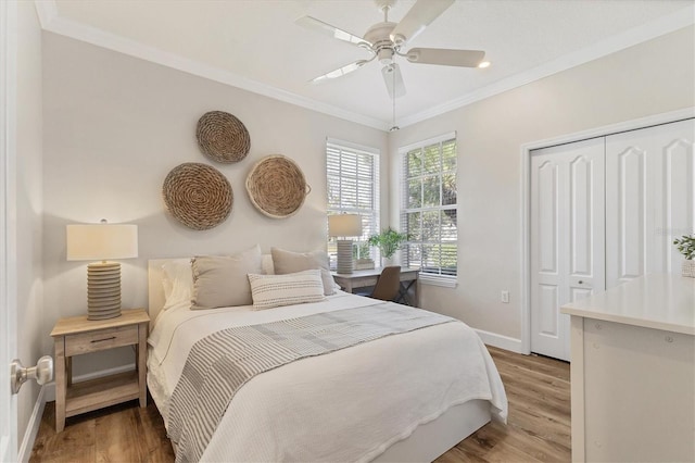 bedroom featuring ceiling fan, a closet, hardwood / wood-style floors, and ornamental molding