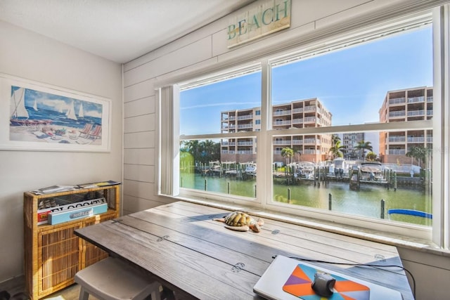 office area featuring wood walls and a water view