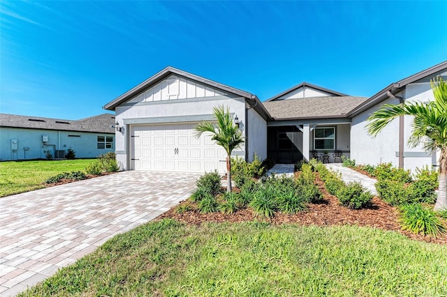 single story home featuring a front lawn, central AC, and a garage