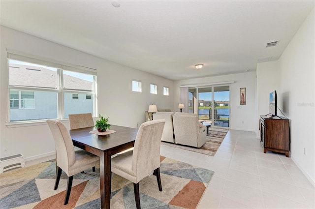 dining area featuring light tile patterned flooring