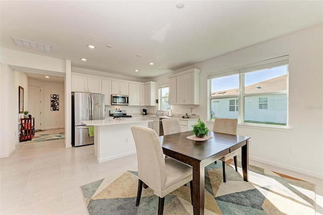 tiled dining room featuring plenty of natural light