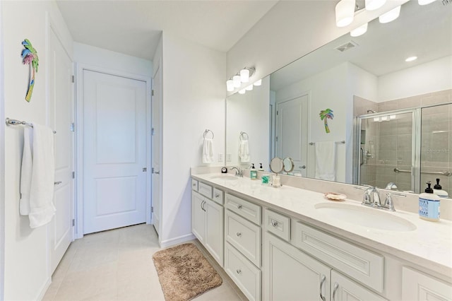 bathroom featuring vanity, tile patterned floors, and walk in shower