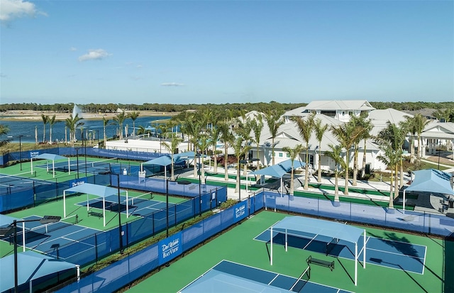 view of tennis court with a water view