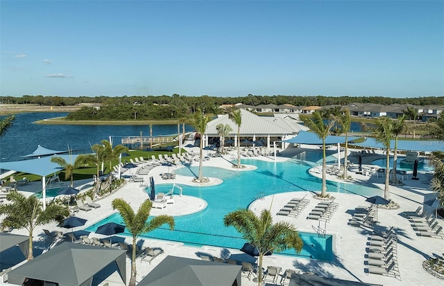 view of swimming pool with a water view and a patio