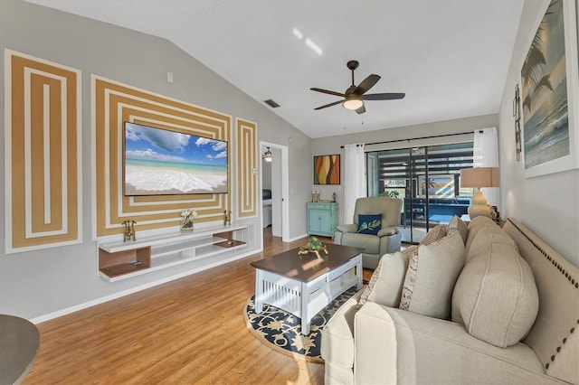 living room featuring hardwood / wood-style floors, vaulted ceiling, and ceiling fan