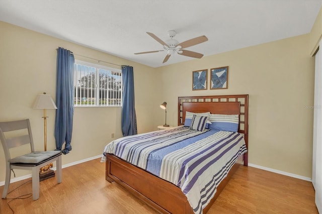 bedroom with light hardwood / wood-style flooring and ceiling fan