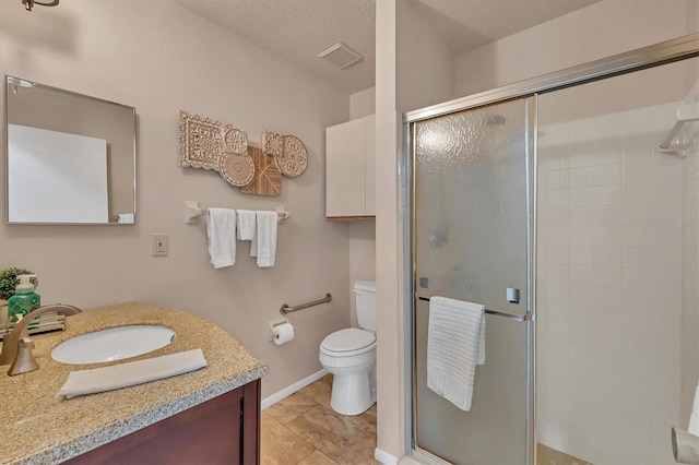 bathroom featuring tile patterned flooring, a textured ceiling, toilet, vanity, and a shower with shower door