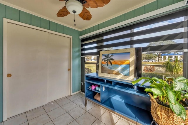 interior space with ceiling fan