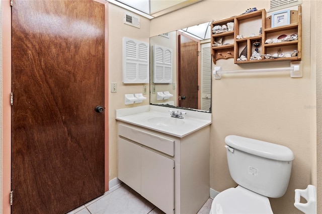 bathroom featuring tile patterned floors, vanity, and toilet