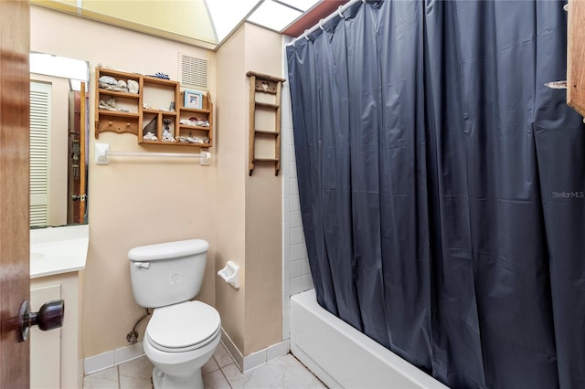 full bathroom with tile patterned floors, shower / tub combo with curtain, vanity, and toilet