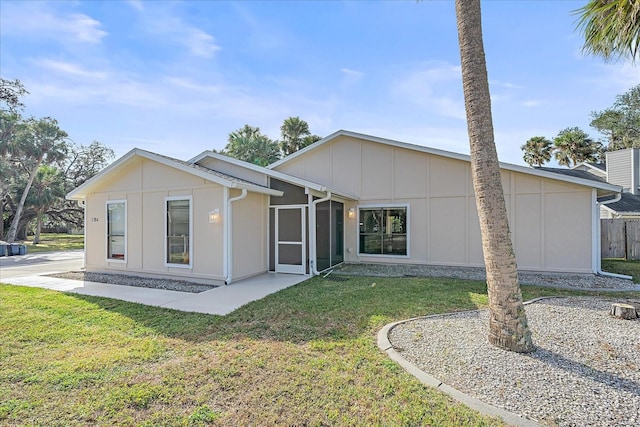 rear view of property with a lawn