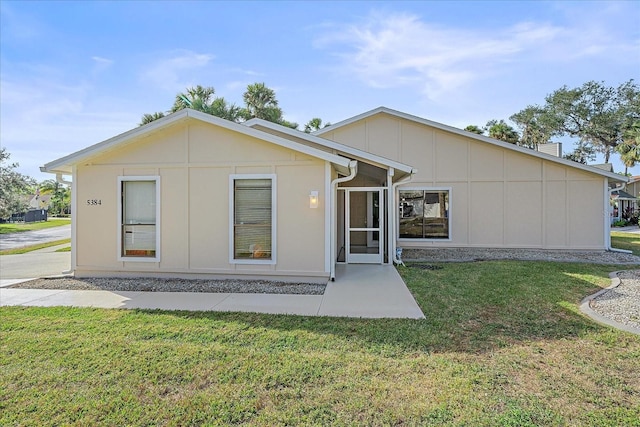 back of property featuring a lawn