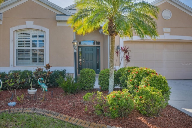 doorway to property with a garage