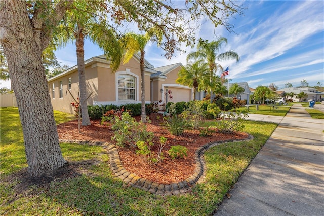 single story home with a garage and a front lawn