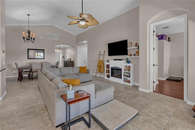 living room with ornamental molding, ceiling fan with notable chandelier, and lofted ceiling