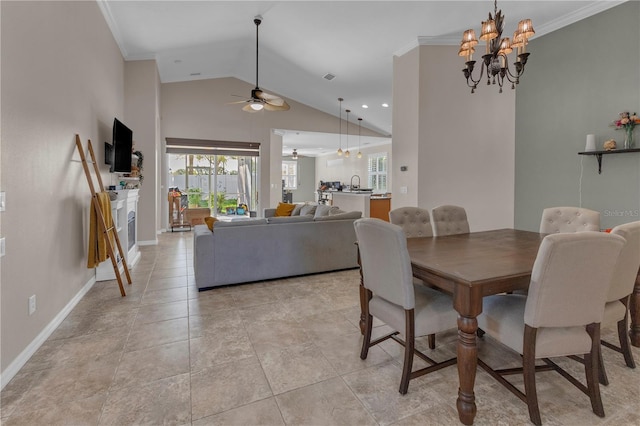 dining area featuring ceiling fan with notable chandelier, sink, crown molding, and vaulted ceiling