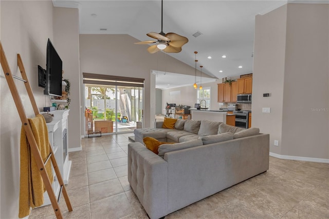 living room featuring ceiling fan, light tile patterned floors, and lofted ceiling