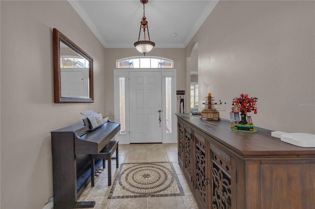 foyer entrance featuring light tile patterned floors and ornamental molding