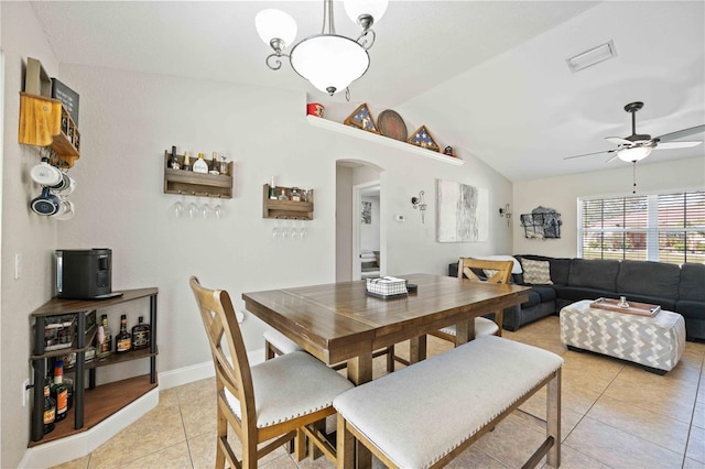 dining area featuring ceiling fan, light tile patterned flooring, and lofted ceiling