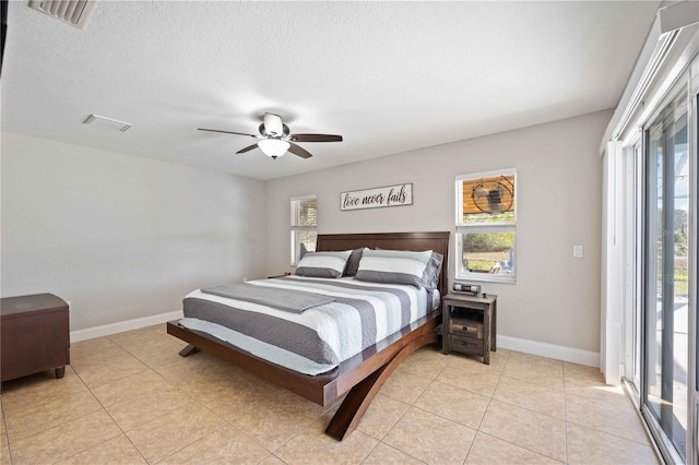 tiled bedroom with a textured ceiling, access to outside, and ceiling fan