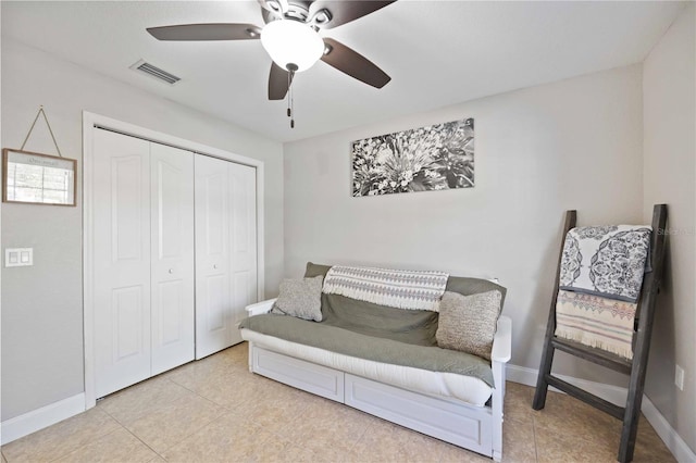 living area featuring ceiling fan and light tile patterned floors