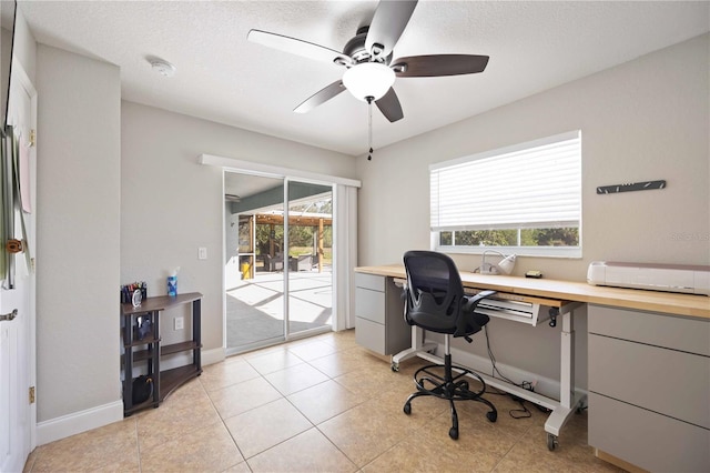 office space with light tile patterned floors, a textured ceiling, and ceiling fan