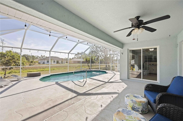 view of swimming pool featuring a patio, ceiling fan, and a lanai