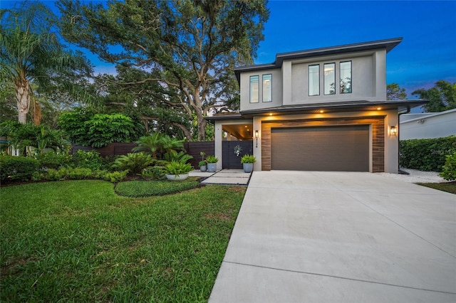 view of front of property with a yard and a garage