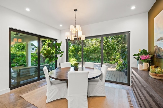 dining area featuring concrete floors, an inviting chandelier, and a healthy amount of sunlight