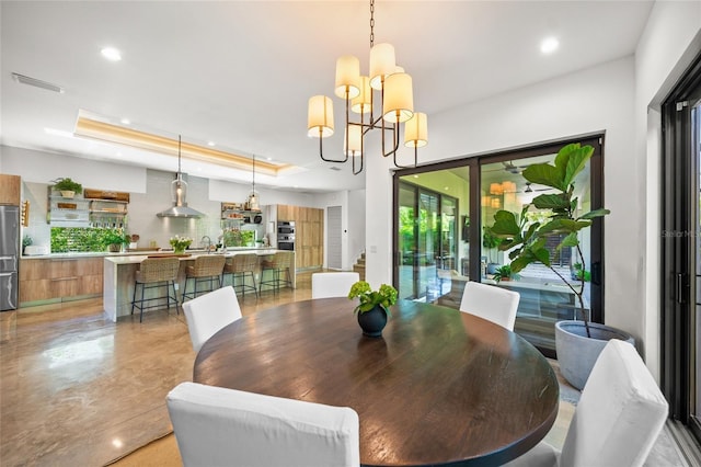 dining room featuring a raised ceiling and a notable chandelier