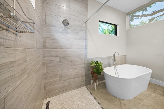 bathroom featuring shower with separate bathtub