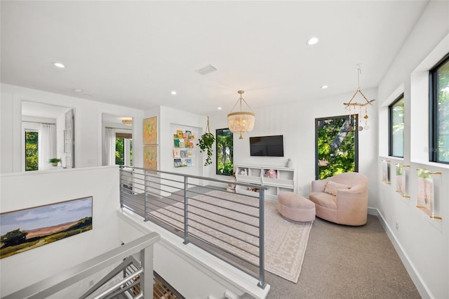 living room featuring a chandelier and carpet