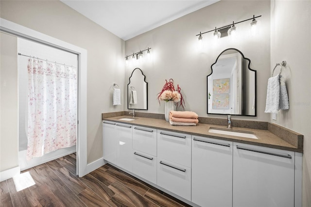 bathroom featuring wood-type flooring, vanity, and shower / bath combination with curtain