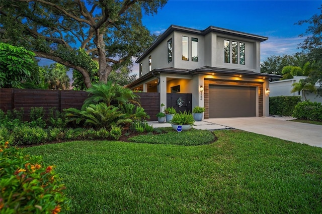 view of front of home with a garage and a yard