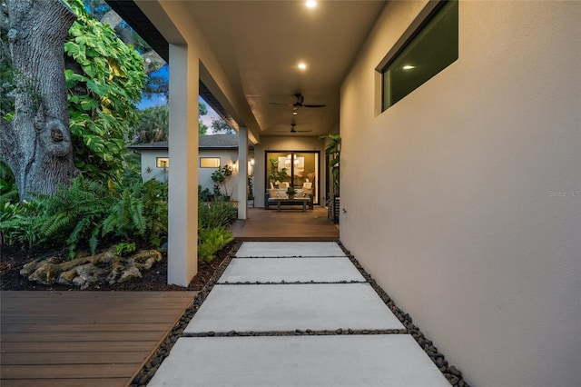 property entrance with a deck and ceiling fan