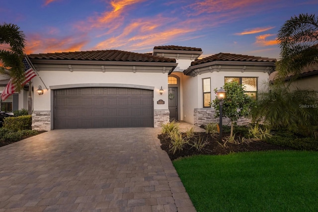 mediterranean / spanish-style home with a garage