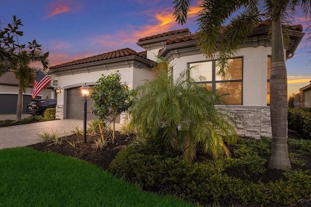 mediterranean / spanish-style home with a garage