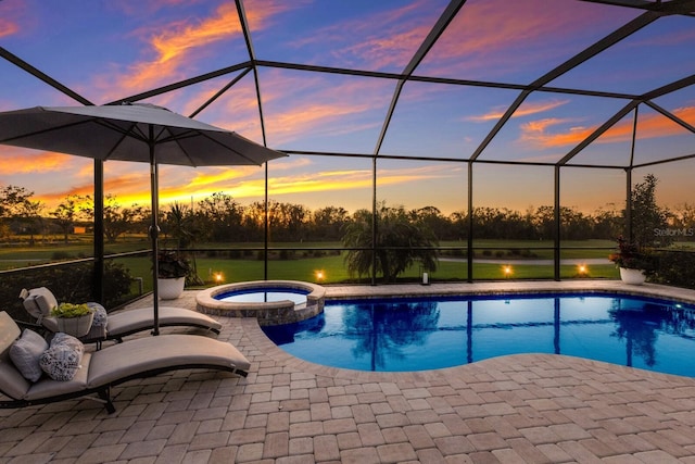 pool at dusk with a lanai, a patio area, a water view, and an in ground hot tub